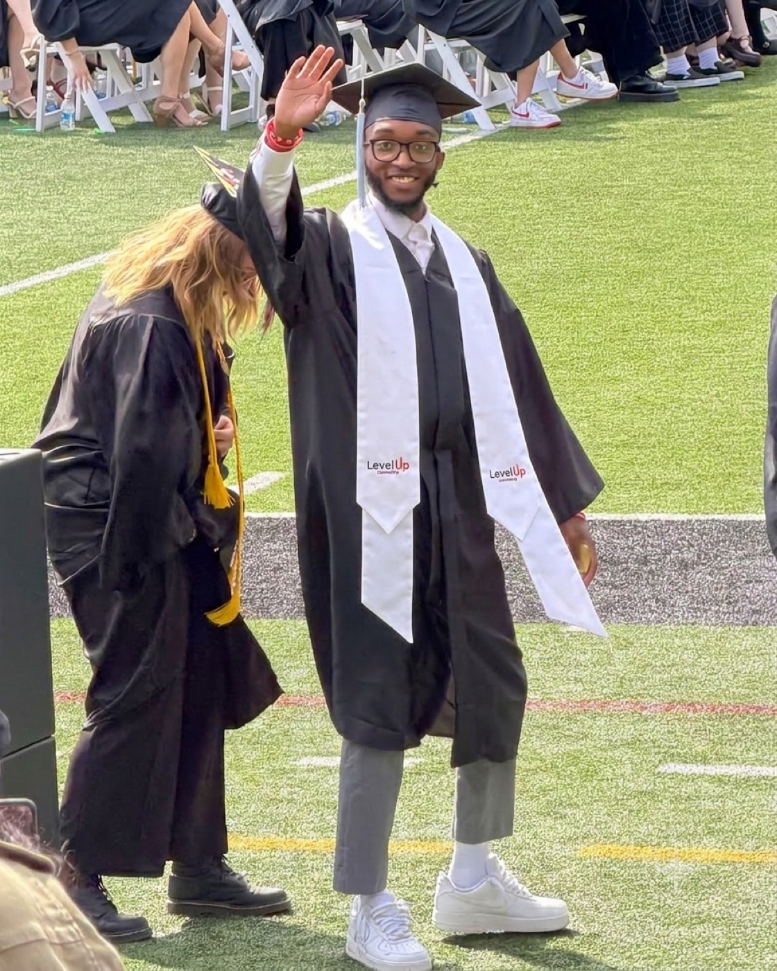 Nate Dunn, 2026 graduate, waving at commencement
